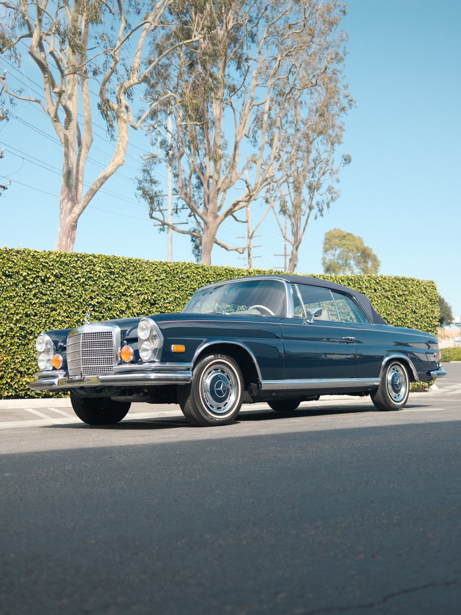 A restored classic coupe parked in the sun after detailing.